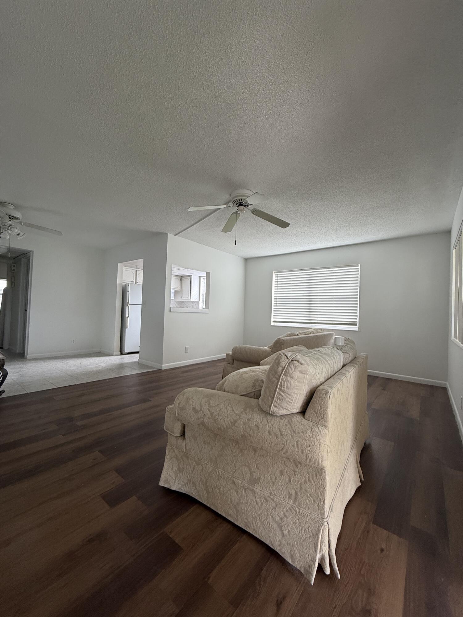 151 Andover F West Palm Beach, FL 33417 - Photo 3 of 10 a bedroom with a bed and wooden floor