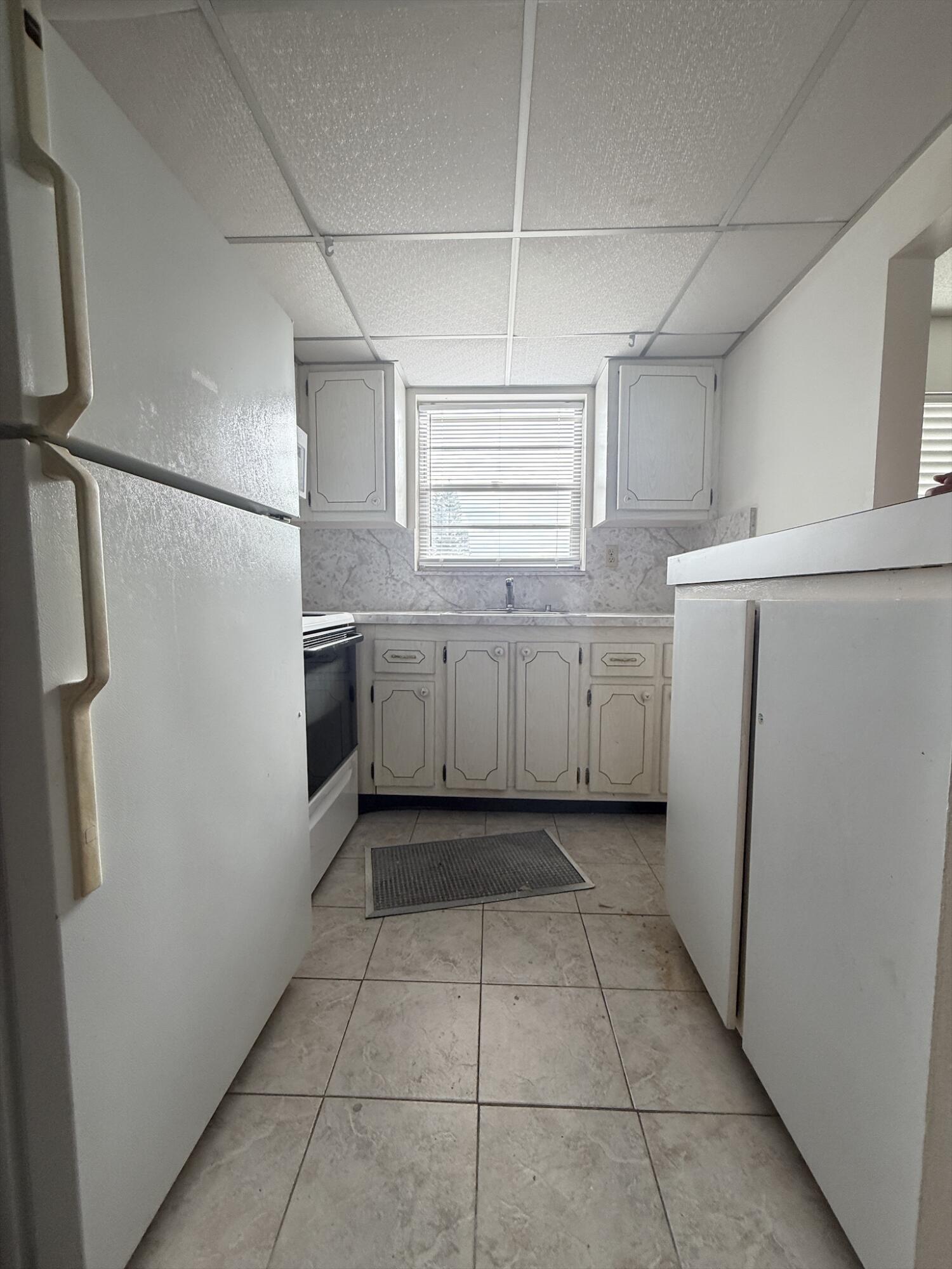 151 Andover F West Palm Beach, FL 33417 - Photo 5 of 10 a kitchen with stainless steel appliances granite countertop a refrigerator and a sink