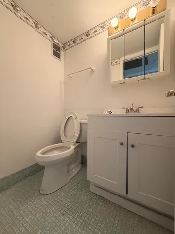 a bathroom with a toilet sink and shower