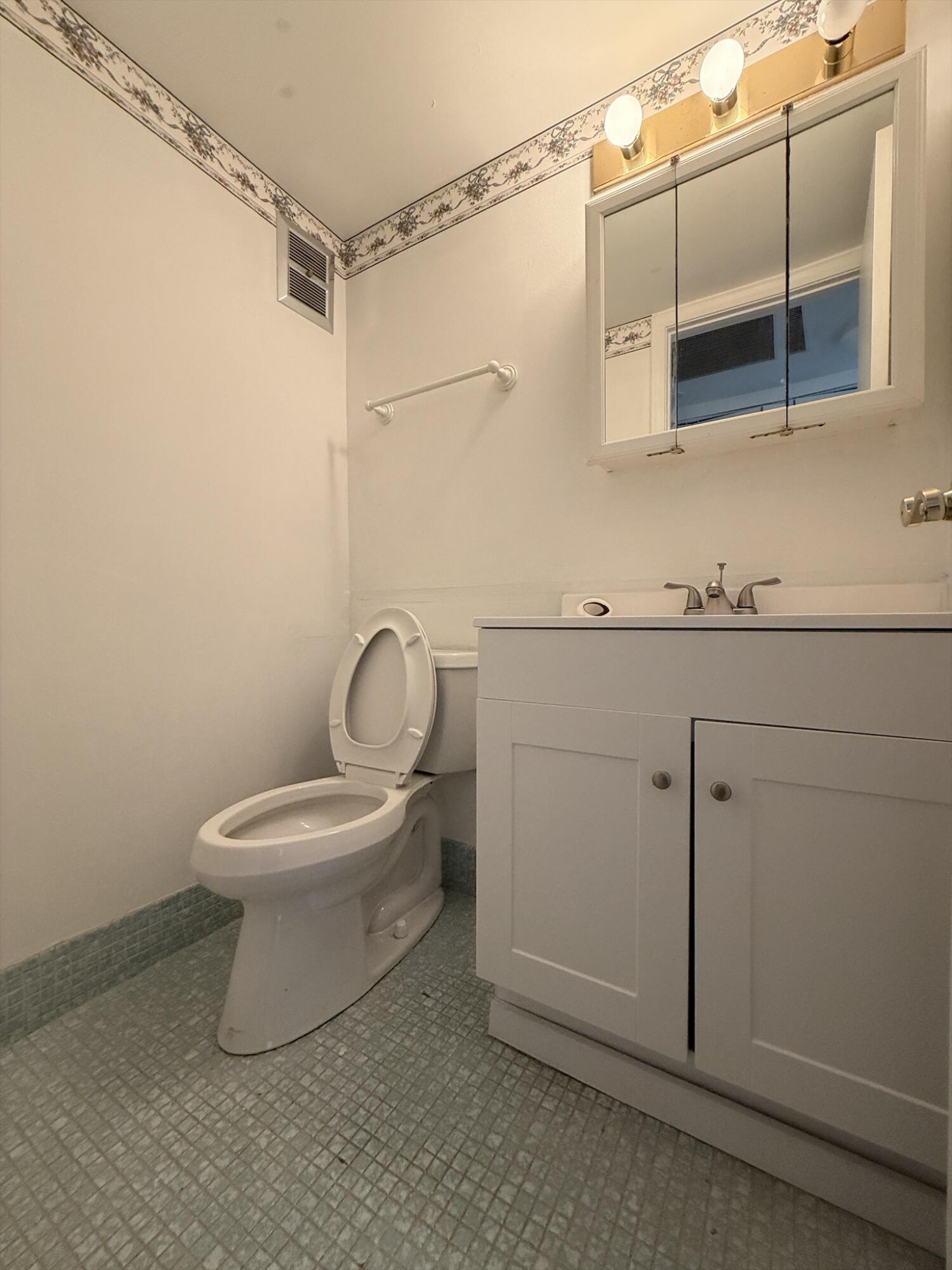 151 Andover F West Palm Beach, FL 33417 - Photo 6 of 10 a bathroom with a toilet sink and shower