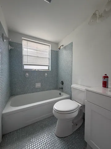 a bathroom with a toilet and a bathtub
