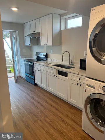 a kitchen with cabinets a sink and a stove top oven