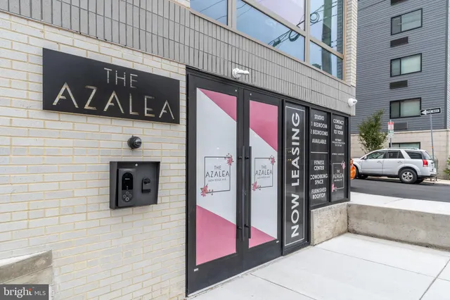 a view of a building with car parked