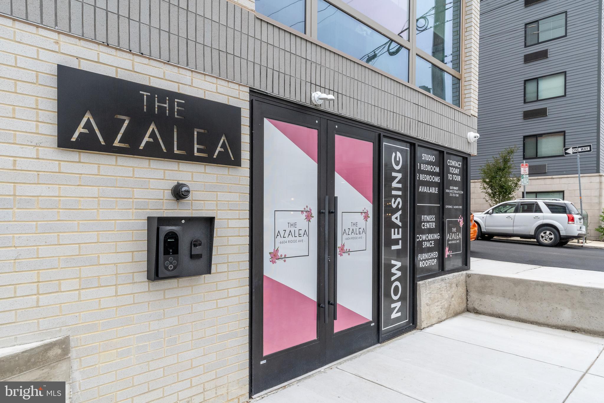 6910 Ridge Avenue, Unit 109 Philadelphia, PA 19128 - Photo 2 of 3 a view of a building with car parked