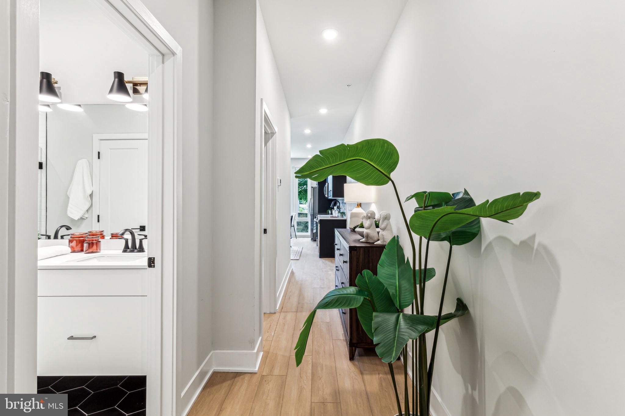 6910 Ridge Avenue, Unit 109 Philadelphia, PA 19128 - Photo 2 of 15 a view of living room with furniture and a potted plant
