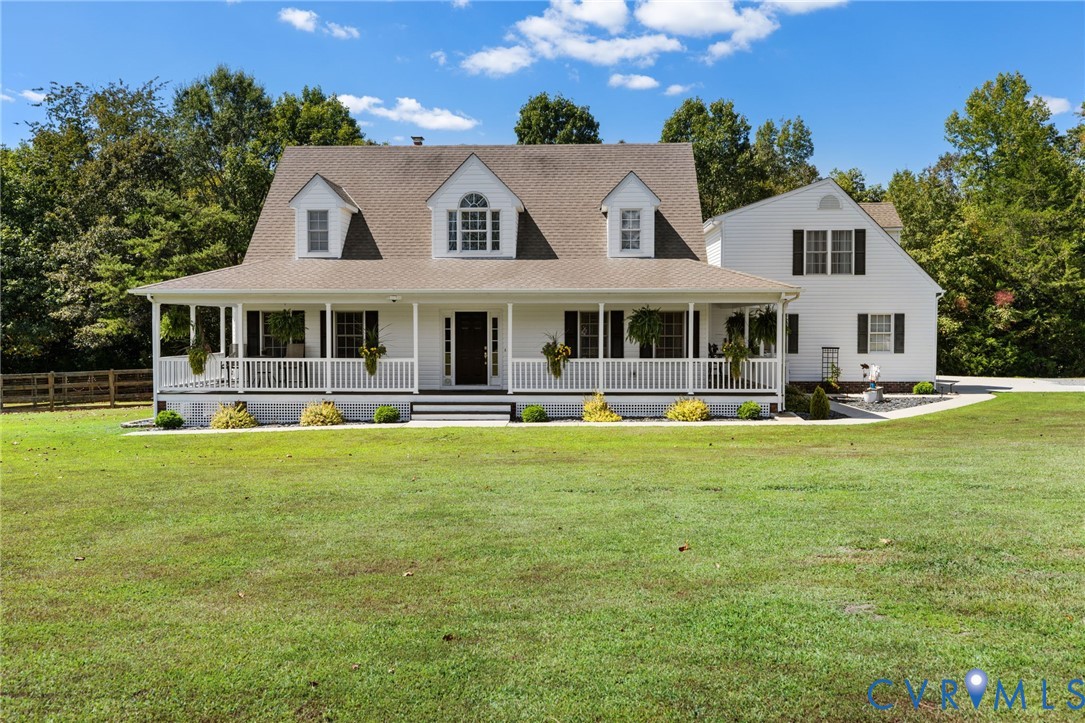 748 Factory Mill Road Bumpass, VA 23024 - Photo 1 of 44 a front view of a house with a yard table and chairs