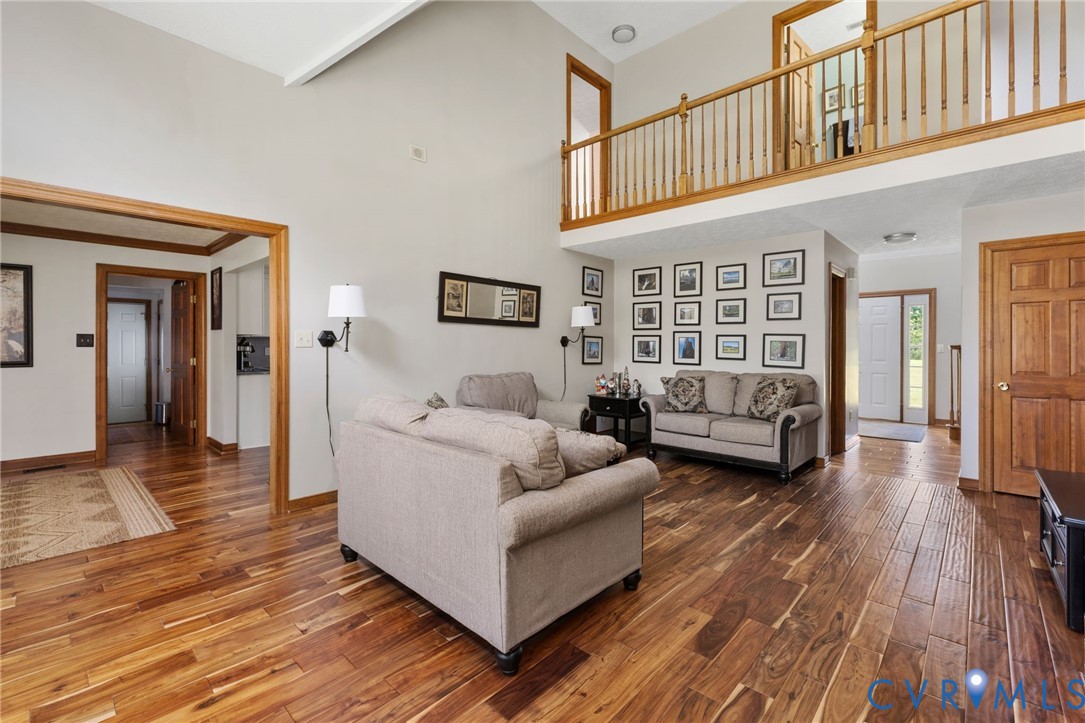748 Factory Mill Road Bumpass, VA 23024 - Photo 11 of 44 a living room with furniture and a wooden floor