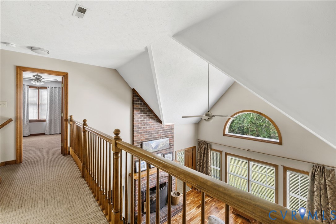 748 Factory Mill Road Bumpass, VA 23024 - Photo 21 of 44 a view of staircase with lots of frames on wall and a window