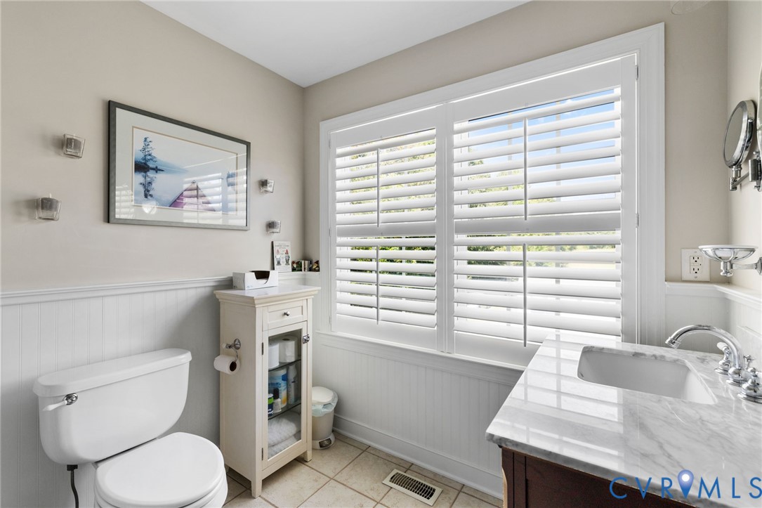 748 Factory Mill Road Bumpass, VA 23024 - Photo 27 of 44 a bathroom with a toilet a sink and a window