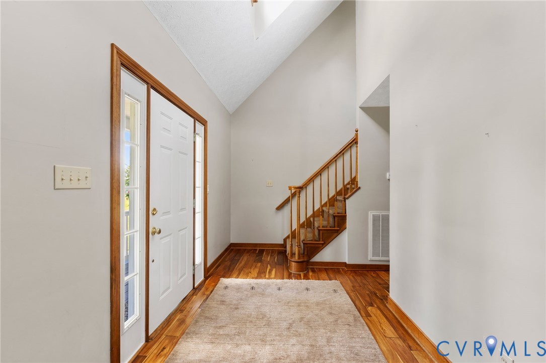 748 Factory Mill Road Bumpass, VA 23024 - Photo 4 of 44 a view of staircase with wooden floor and a rug