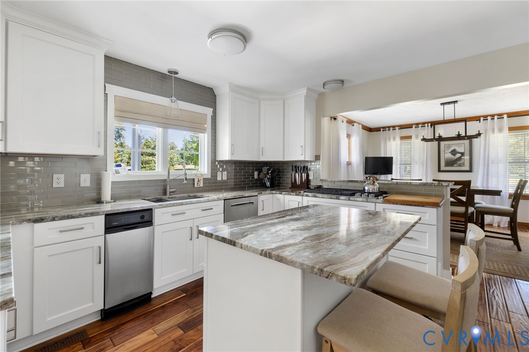 748 Factory Mill Road Bumpass, VA 23024 - Photo 7 of 44 a kitchen with granite countertop a sink and white cabinets