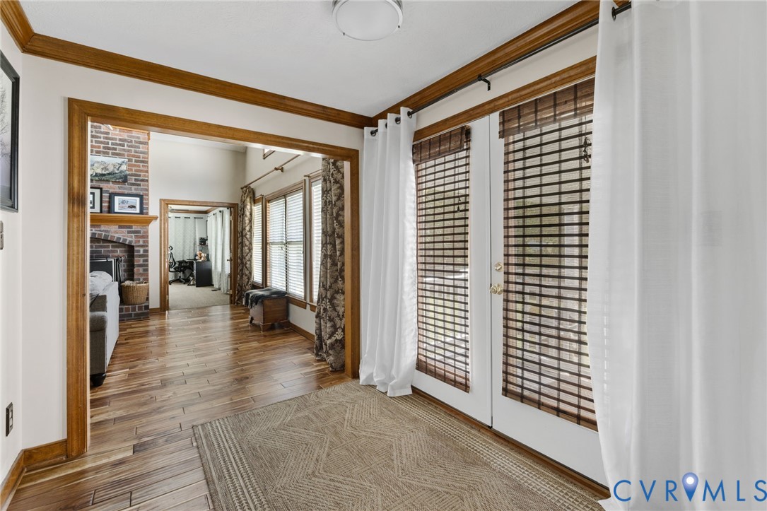 748 Factory Mill Road Bumpass, VA 23024 - Photo 9 of 44 a view of a hallway with wooden floor and a living room