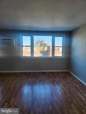 a kitchen with stainless steel appliances granite countertop a refrigerator a stove and a sink with wooden floor