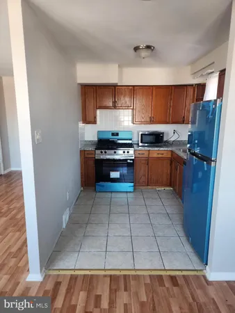 a kitchen with stainless steel appliances granite countertop a refrigerator and a stove