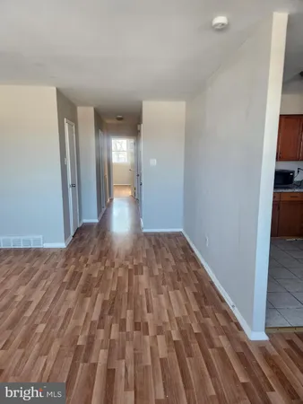 a view of a room with wooden floor