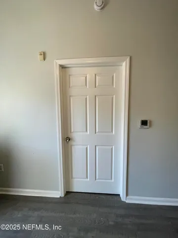 an empty room with wooden floor