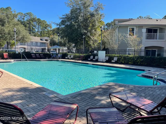 a view of a house with backyard porch and sitting area