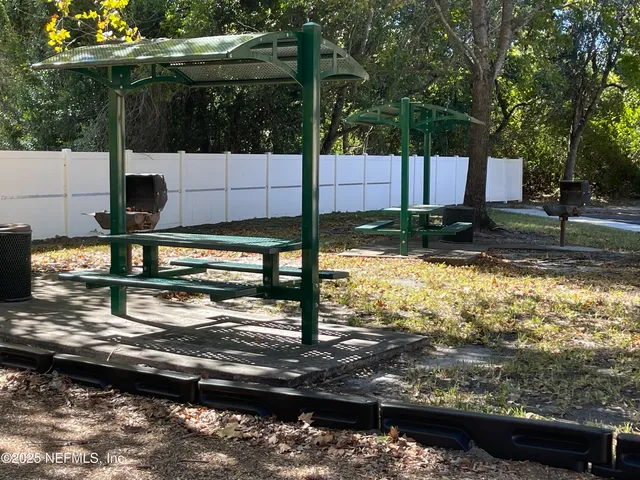a view of a yard with wooden fence