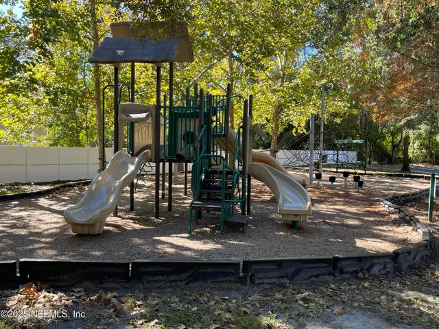 a view of a house with backyard water fountain and sitting area