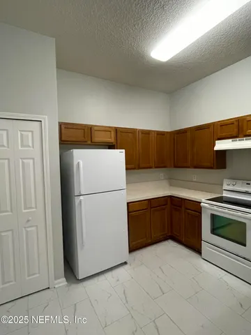 a kitchen with a refrigerator sink and stove