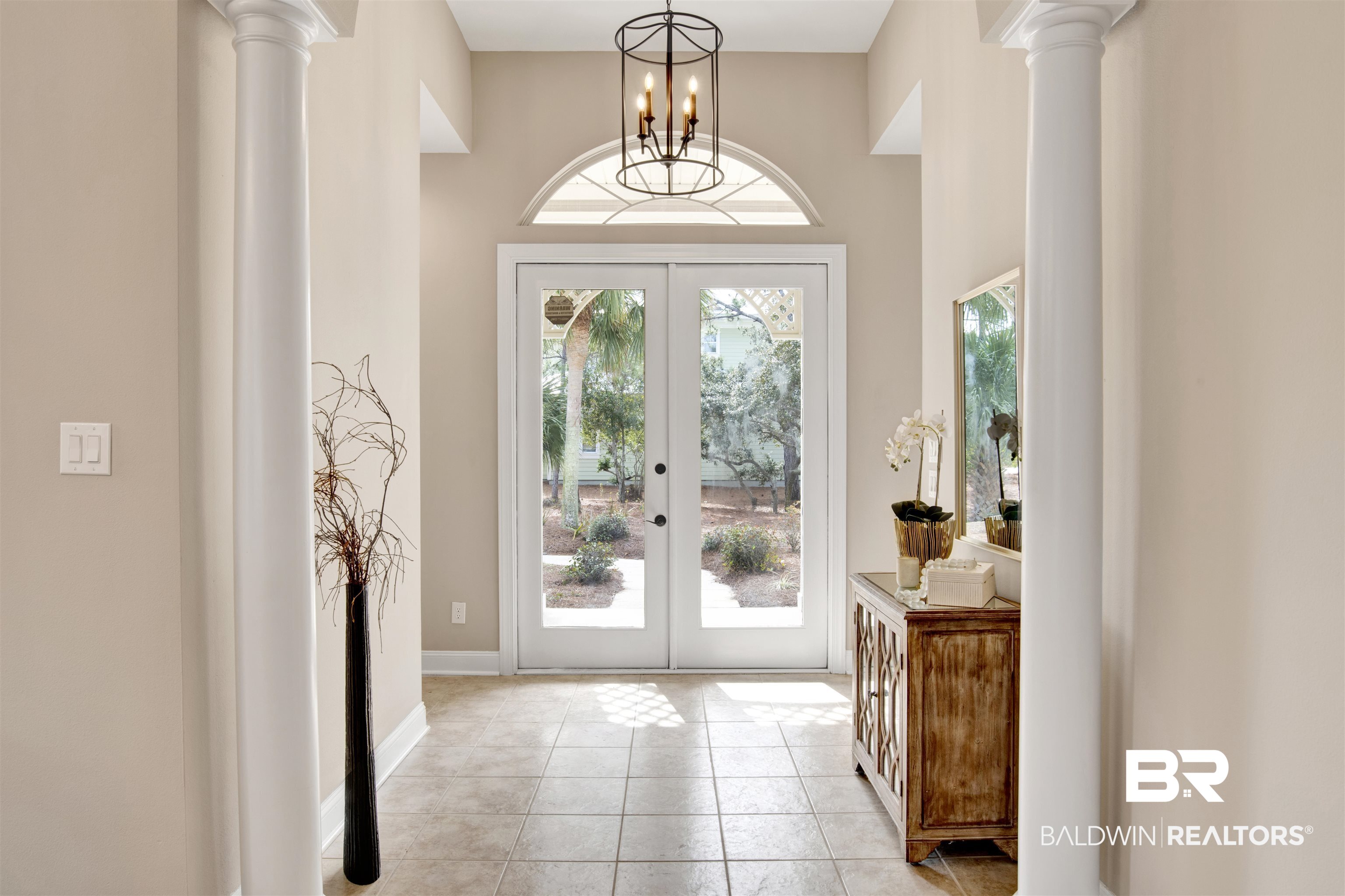 9259 Genipa Way Gulf Shores, AL 36542 - Photo 8 of 72 Tiled foyer entrance featuring decorative columns, a chandelier, and french doors