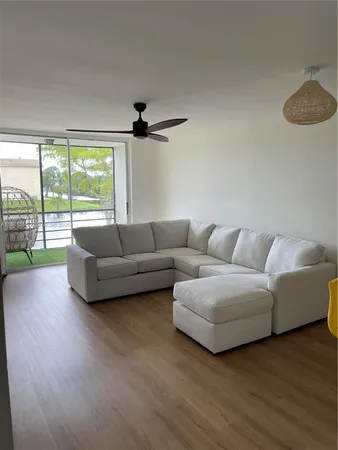 a living room with furniture and a floor to ceiling window