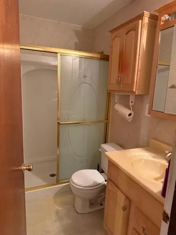 a view of an empty room with a chandelier fan