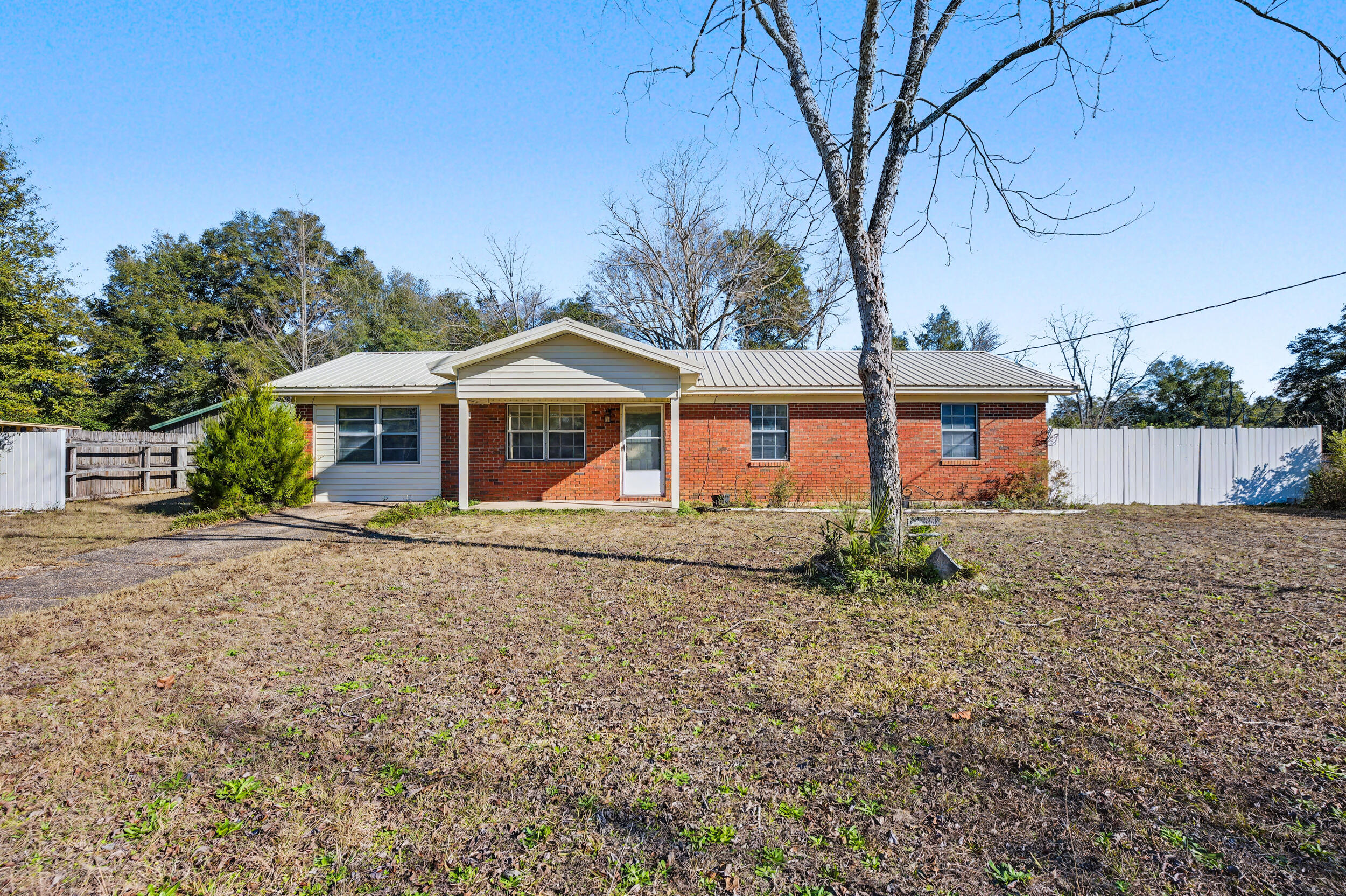 1208 Sunshine Drive Crestview, FL 32539 - Photo 2 of 38 front view of a house with a tiny house