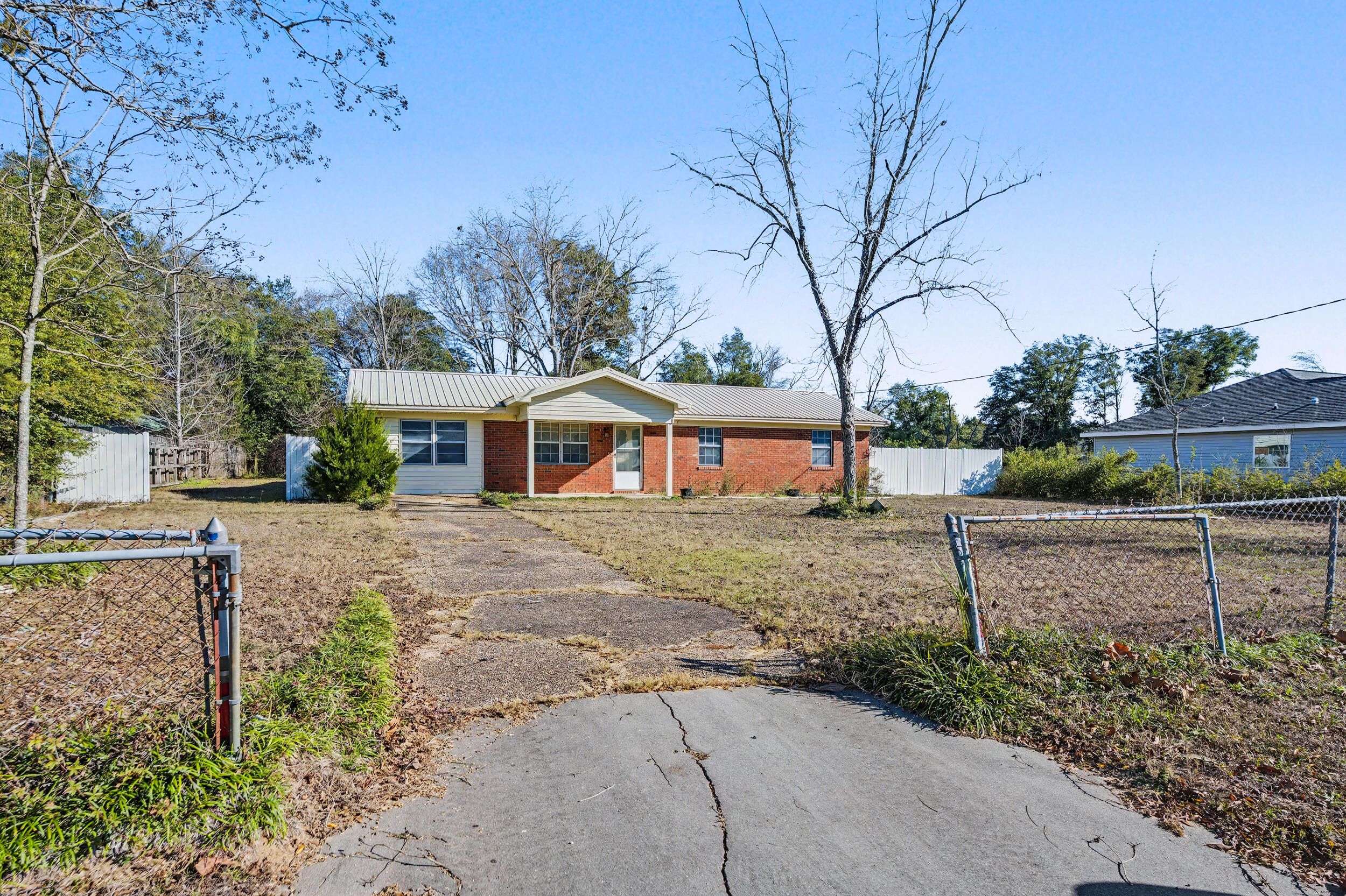 1208 Sunshine Drive Crestview, FL 32539 - Photo 3 of 38 a front view of a house with a yard