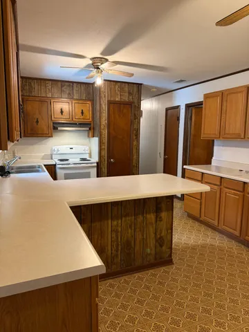 a kitchen with stainless steel appliances a stove a sink and a refrigerator