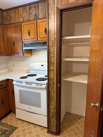 a kitchen with stainless steel appliances granite countertop a stove and a microwave