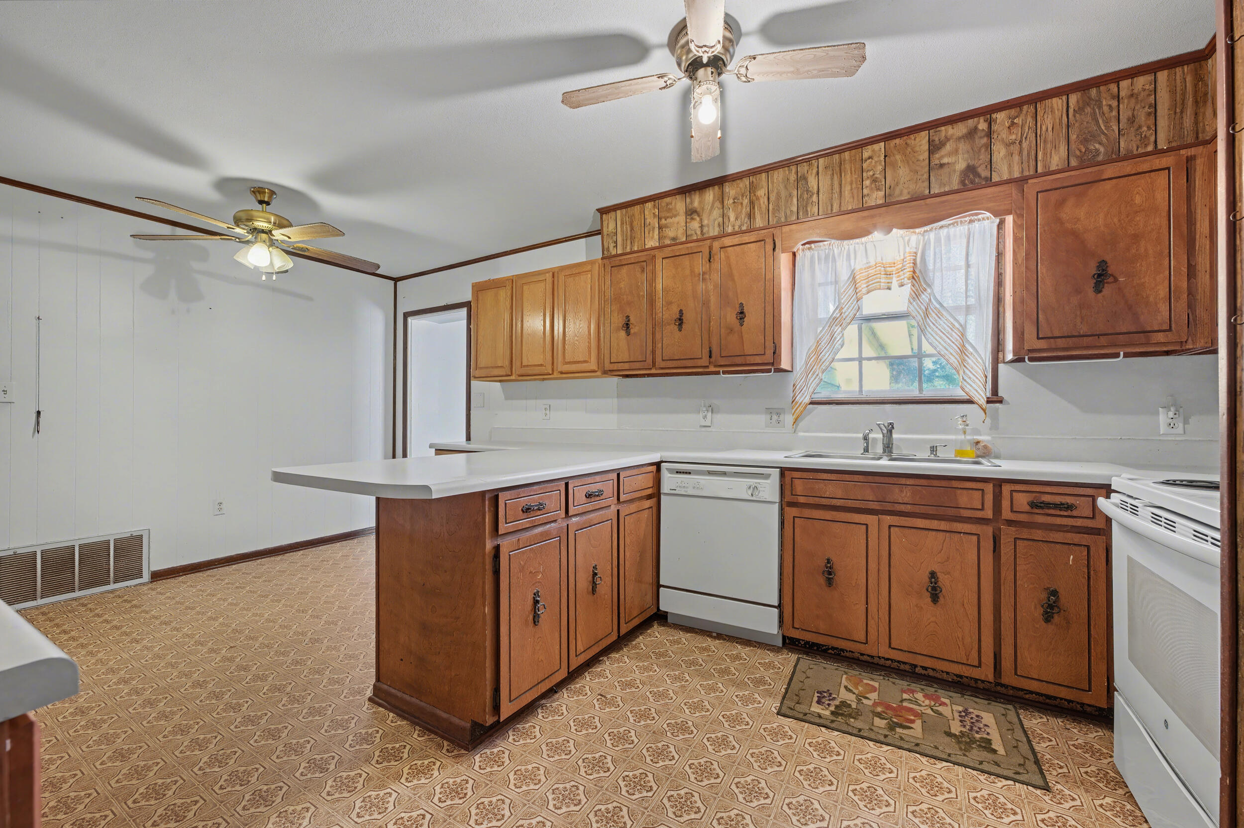 1208 Sunshine Drive Crestview, FL 32539 - Photo 8 of 38 a kitchen with stainless steel appliances granite countertop a sink cabinets and wooden floor
