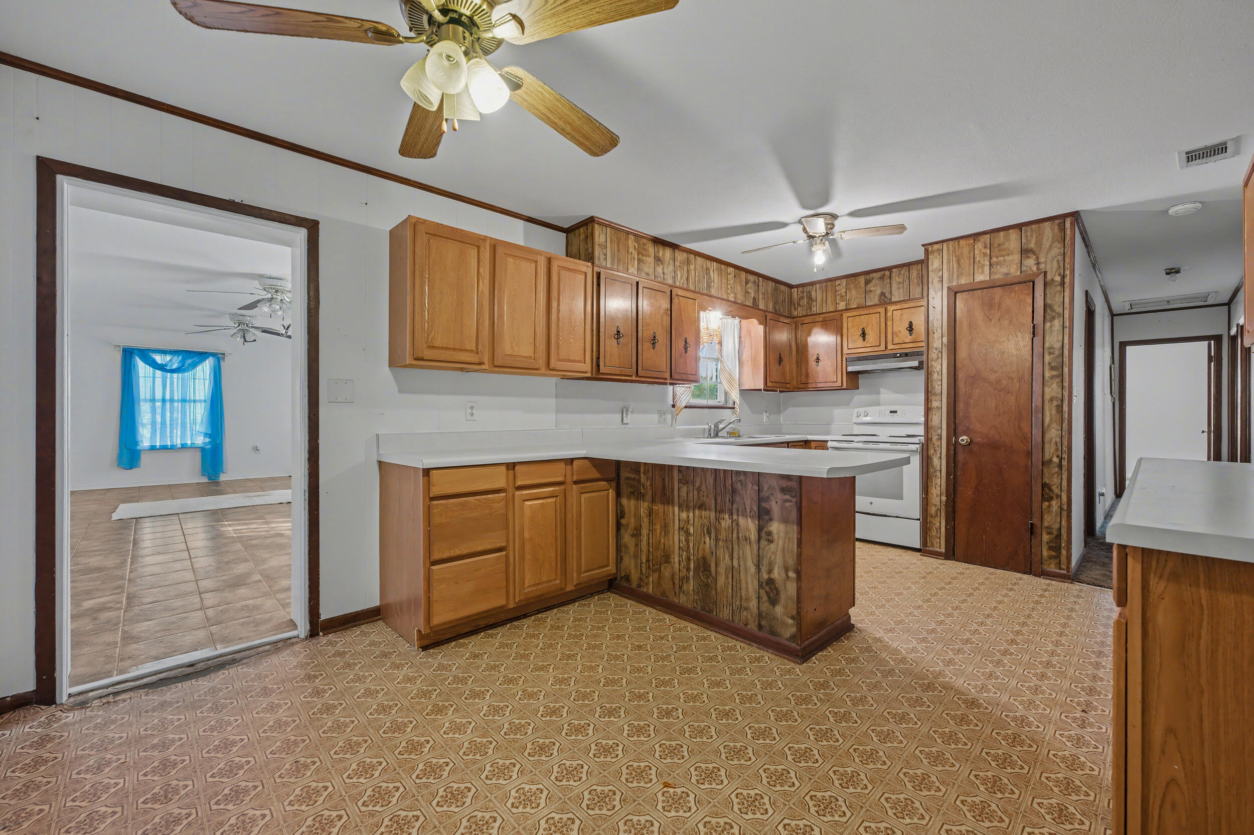 1208 Sunshine Drive Crestview, FL 32539 - Photo 10 of 38 a kitchen with a refrigerator a sink and cabinets