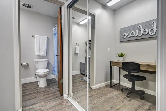 a view of a room with wooden floor and furniture