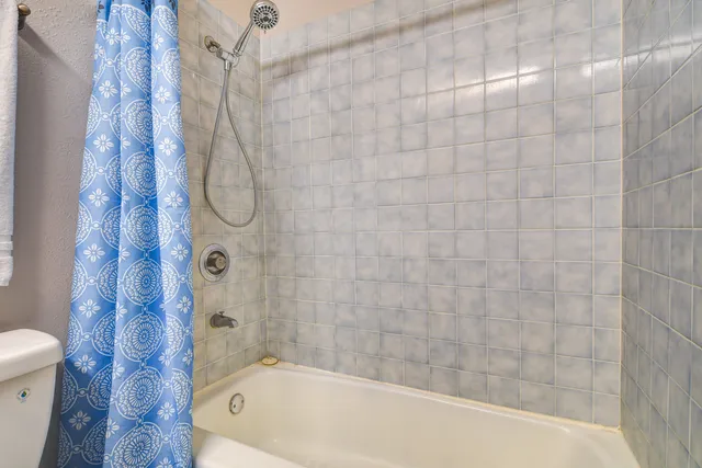 a bathroom with a bathtub and shower