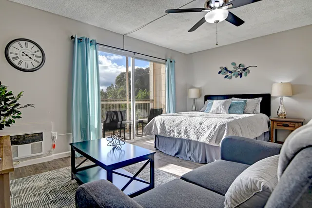 a bedroom with a bed a chandelier and a bookshelf