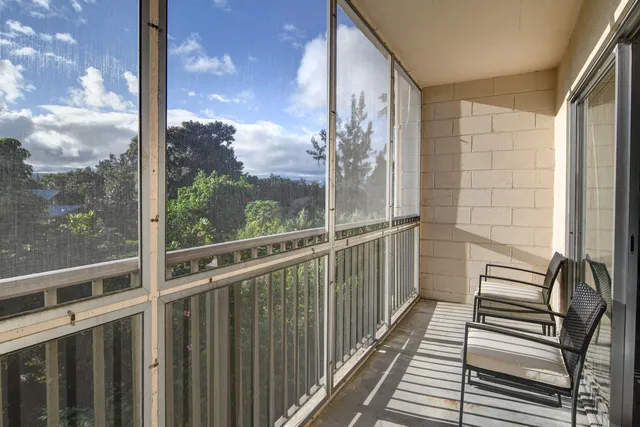 a view of a balcony with wooden floor