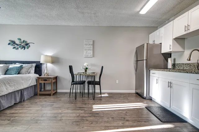 a living room with furniture and kitchen view