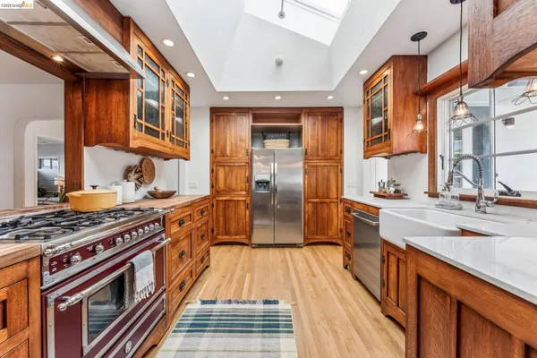 a kitchen with stainless steel appliances granite countertop a stove and a sink