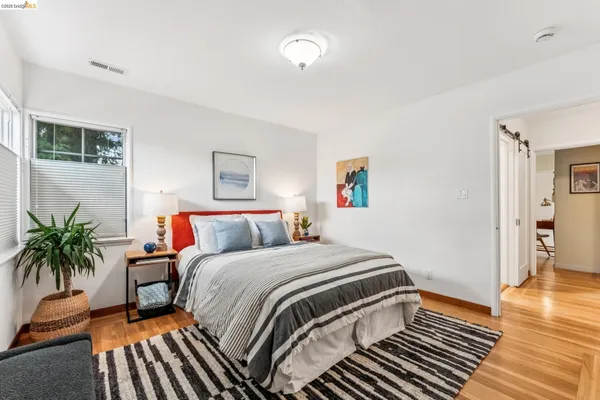 a bedroom with a bed and a potted plant