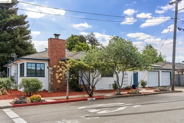 a view of a house with a tree next to a road