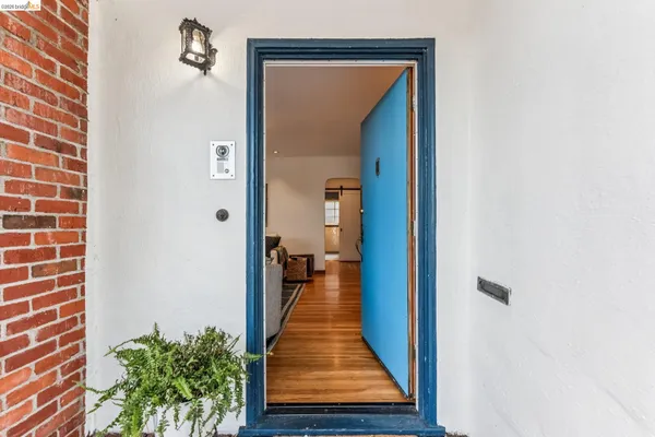 a view of a hallway with a door and wooden floor
