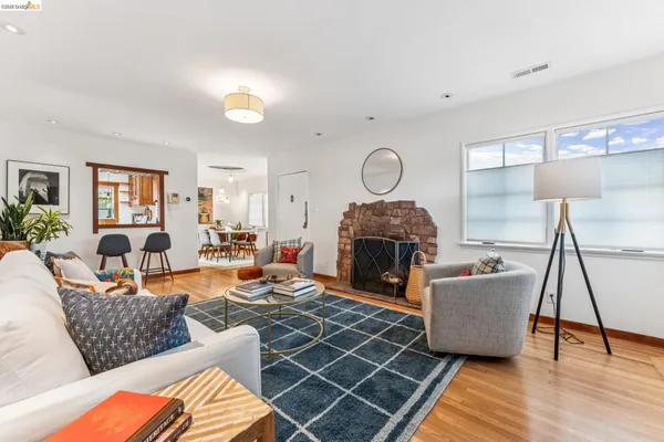 a living room with furniture a fireplace and a chandelier