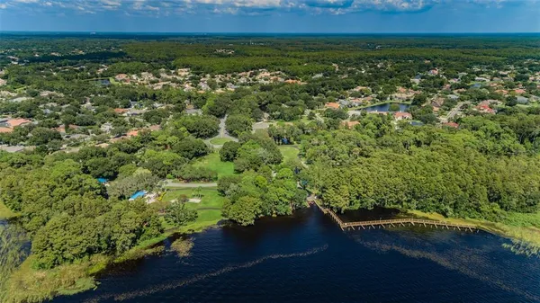 an aerial view of a house with a lake view