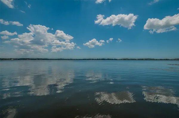 a view of a park with bench and trees