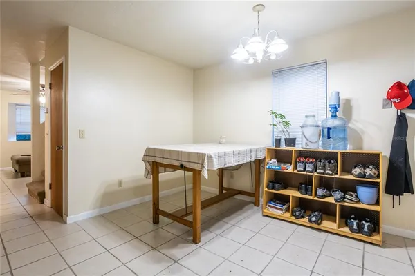 a room with furniture a chandelier and a bookshelf