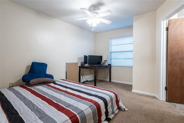 a bedroom with a bed and a television