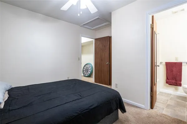 a bedroom with a bed and a mirror