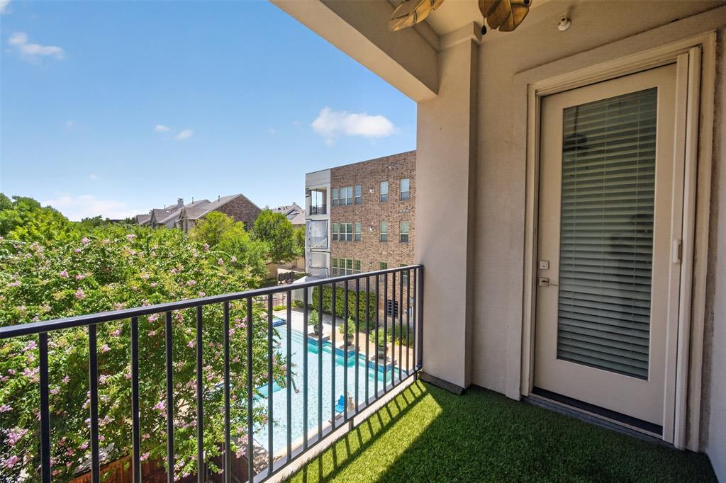 5015 Meridian Lane, Unit 2102 Addison, TX 75001 - Photo 28 of 36 Private balcony featuring faux turf flooring, black metal railings, and an exterior door with integrated blinds