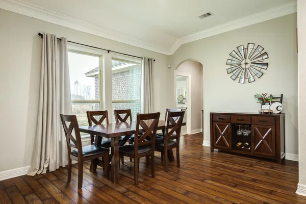a view of a dining room with furniture and wooden floor